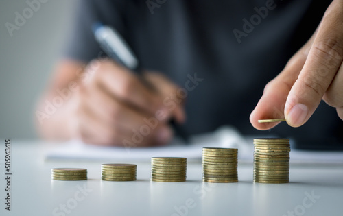 Businessman saving money concept financial. hand holding coins putting on stack. concept of saving money for finance accounting.