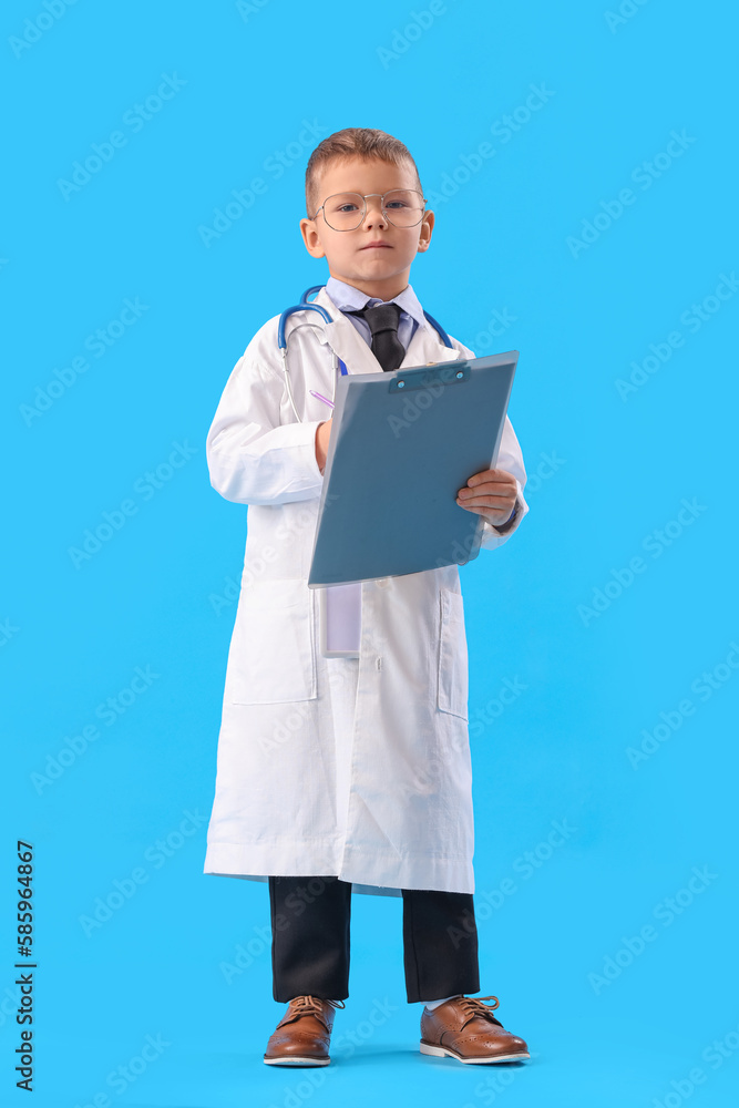Cute little doctor with clipboard on blue background Cute little doctor with clipboard on blue background