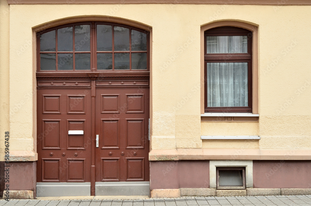 View of old building with wooden door and window View of old building with wooden door and window