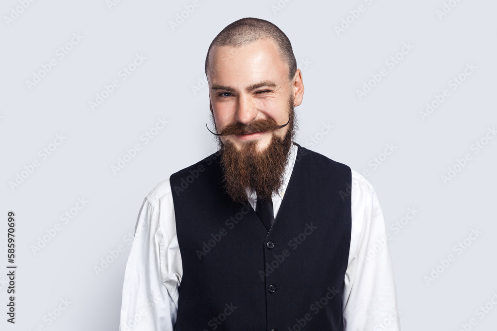 Positive happy handsome man standing and winking to camera, flirting with somebody. Positive happy handsome man standing and winking to camera, flirting with somebody.