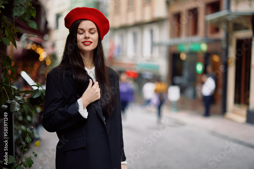 Woman fashion model walks on the street in the city center among the crowd in a jacket and red beret and jeans, cinematic french fashion style clothing, travel to istanbul © SHOTPRIME STUDIO
