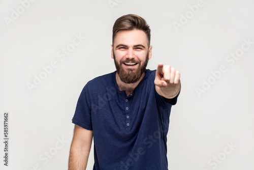 Valokuva Amused handsome man laughing out loud, pointing finger to camera, indicating ridiculous idiot