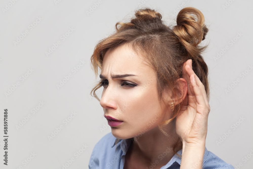 Woman trying to overhear someone, holding hand near ear, tries to understand words eavesdropping. Woman trying to overhear someone, holding hand near ear, tries to understand words eavesdropping.