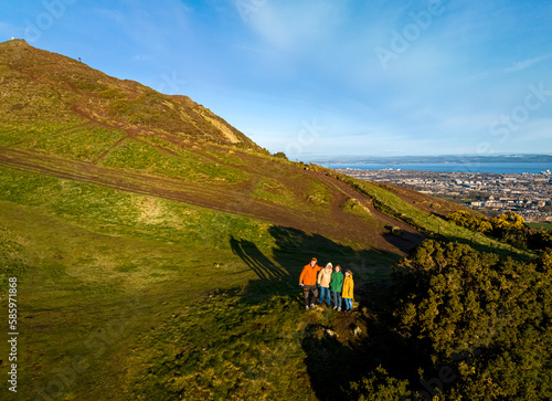 Aerial view of ffamily climbing the Arthurs seat in  Edinburgh photo