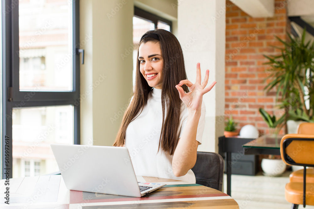 pretty young woman with a laptop working at home. house interior design pretty young woman with a laptop working at home. house interior design