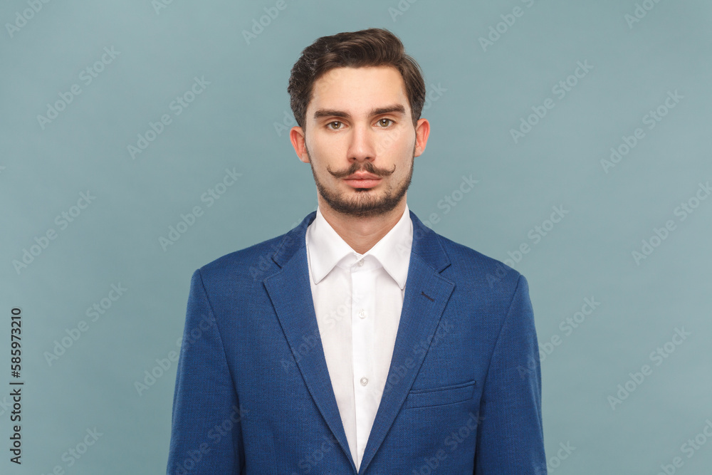Serious strict bossy man with mustache standing looking at camera, being in bad mood. Serious strict bossy man with mustache standing looking at camera, being in bad mood.