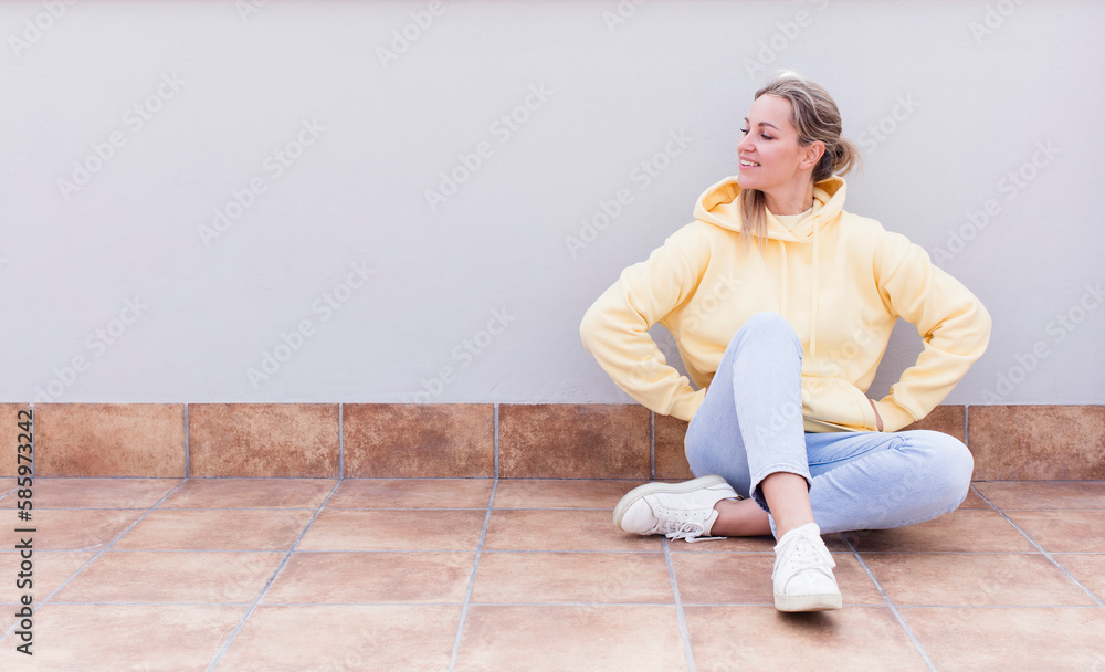 pretty caucasian sitting woman looking happy, cheerful and confident, smiling proudly and looking to side with both hands on hips pretty caucasian sitting woman looking happy, cheerful and confident, smiling proudly and looking to side with both hands on hips