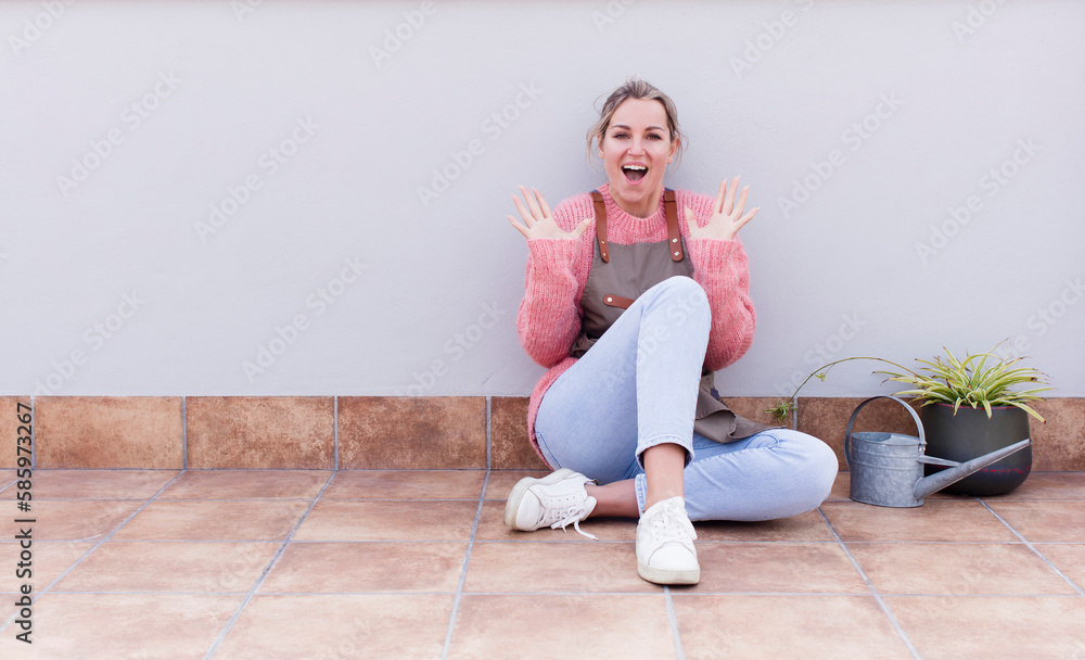 looking happy and excited, shocked with an unexpected surprise with both hands open next to face. gardering concept looking happy and excited, shocked with an unexpected surprise with both hands open next to face. gardering concept