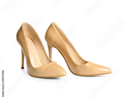 Pair of beige high heeled shoes on white background