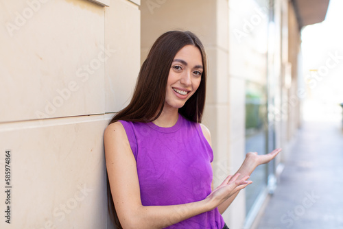 Free Download young pretty woman feeling happy and cheerful, smiling and welcoming you, inviting you in with a friendly gesture - GFXLoad