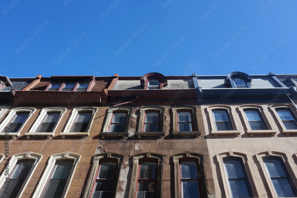 Obraz premium Windows of Traditional High Rise Meet Blue Sky