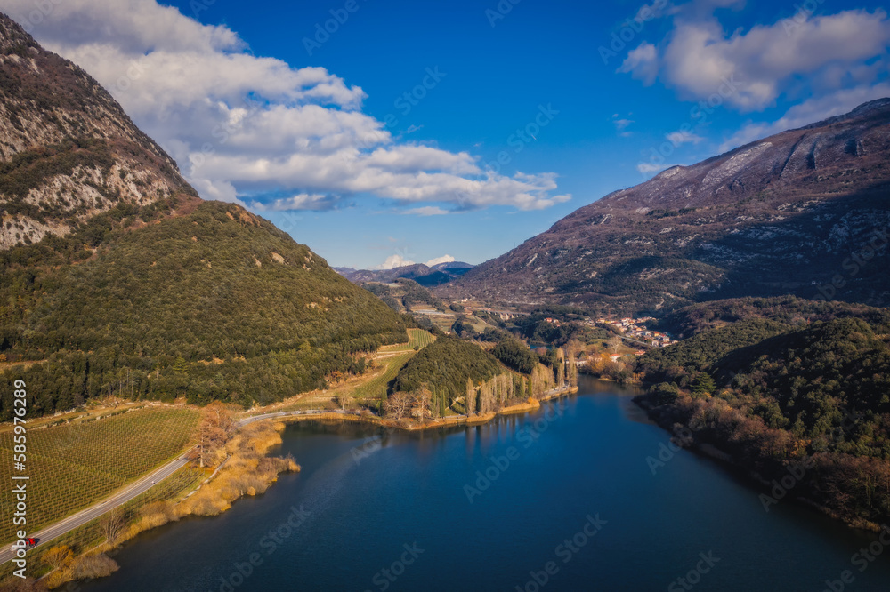 Panoramic aerial drone view on lake Toblino and mountains in sunny winter day. January 2023