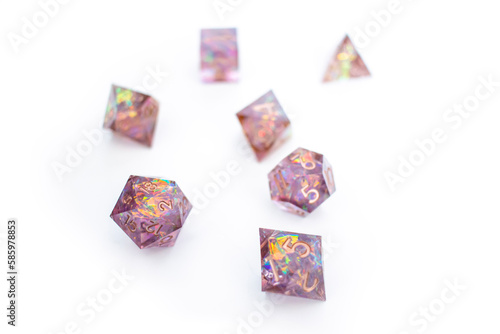 Collection of light purple glittery dice of various sizes against a white background