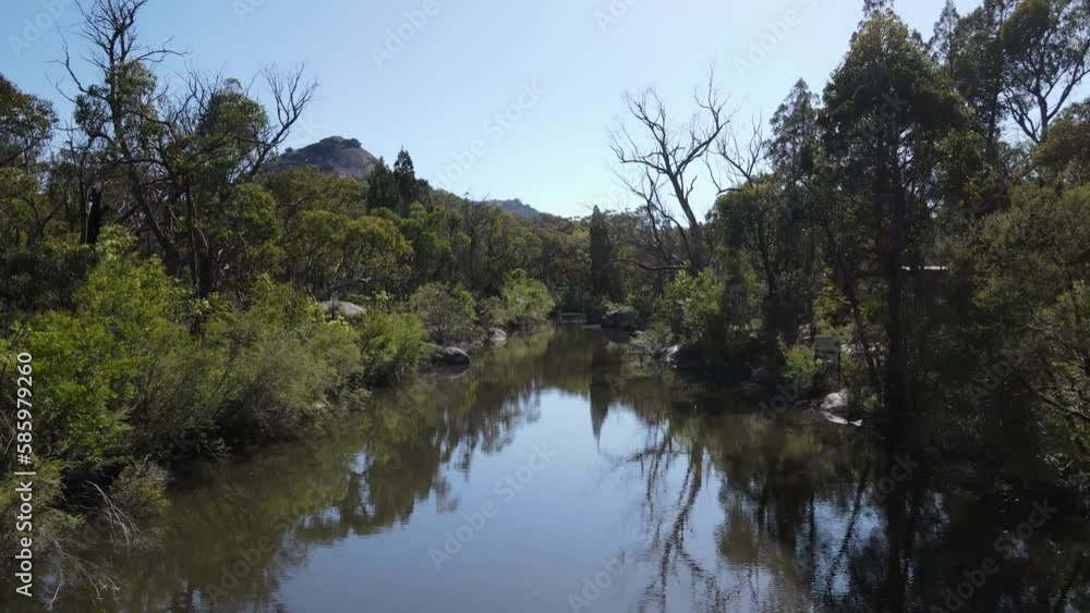 Secluded swimming waterhole below the towering granite rock mountains in the Girraween National Park Australia. Drone view Secluded swimming waterhole below the towering granite rock mountains in the Girraween National Park Australia. Drone view