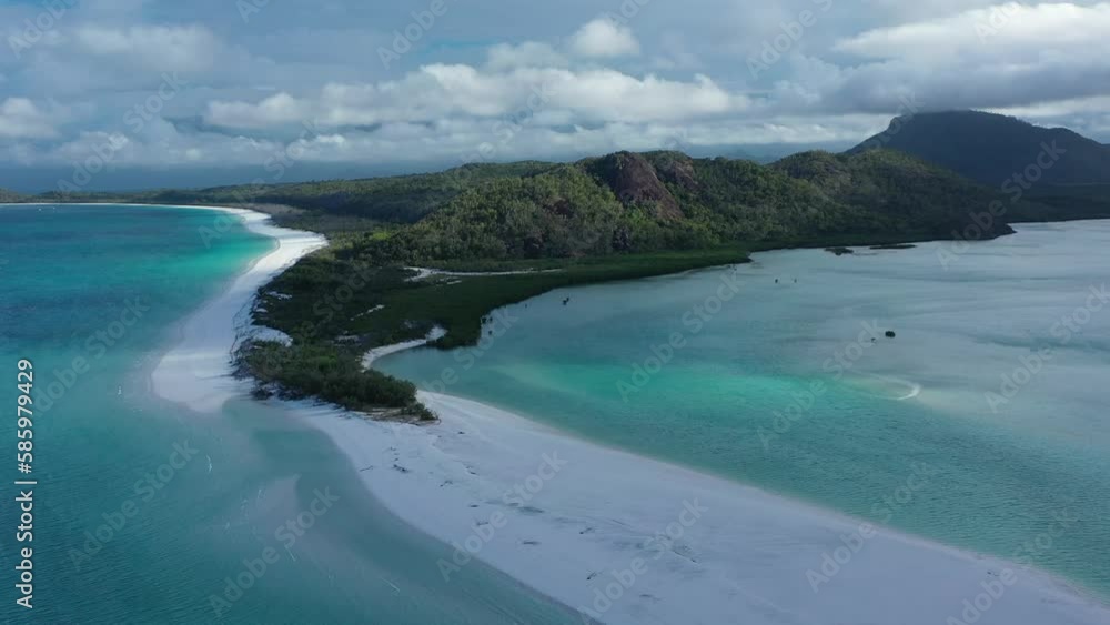 Drone shot off Whitsunday Island's peninsula. Shot on an overcast day with cloudy sky. Ocean water is clear with very white sand. Shot on the Whitsunday Islands, Queensland Tourism Australia Drone shot off Whitsunday Island's peninsula. Shot on an overcast day with cloudy sky. Ocean water is clear with very white sand. Shot on the Whitsunday Islands, Queensland Tourism Australia