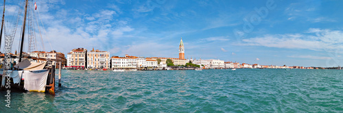 Panoramic view of central Venice from across the sea. This travel banner panorama features the stunning water in front of this Italian city.