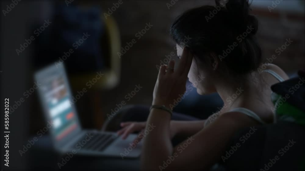Person working at night in front of laptop. Woman using computer studying in the evening and browsing internet online. Candid modern lifestyle Person working at night in front of laptop. Woman using computer studying in the evening and browsing internet online. Candid modern lifestyle