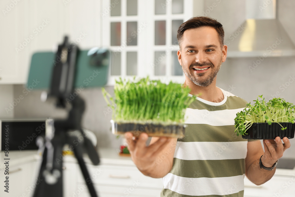 Teacher with microgreens conducting online course in kitchen. Time for hobby Teacher with microgreens conducting online course in kitchen. Time for hobby
