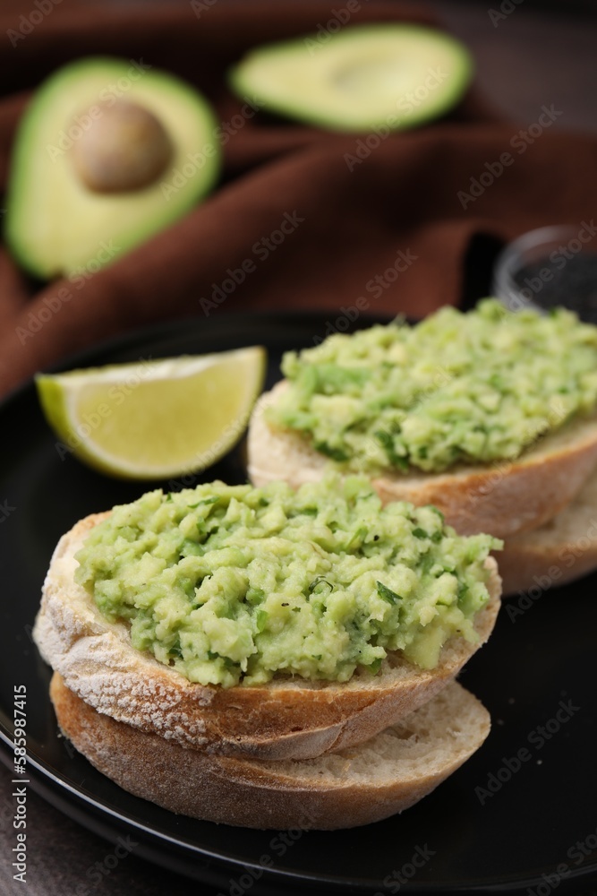 Delicious sandwiches with guacamole on black plate, closeup Delicious sandwiches with guacamole on black plate, closeup