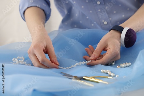 Dressmaker creating new dress in atelier  closeup