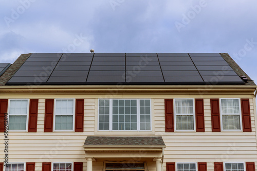 solar panels on the roof of new built houses collecting green energy from the sun in a modern and sustainable way