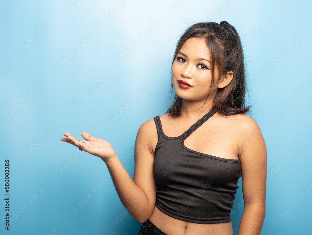 Cute philippine girl marketing invisible product against a blue background Cute philippine girl marketing invisible product against a blue background