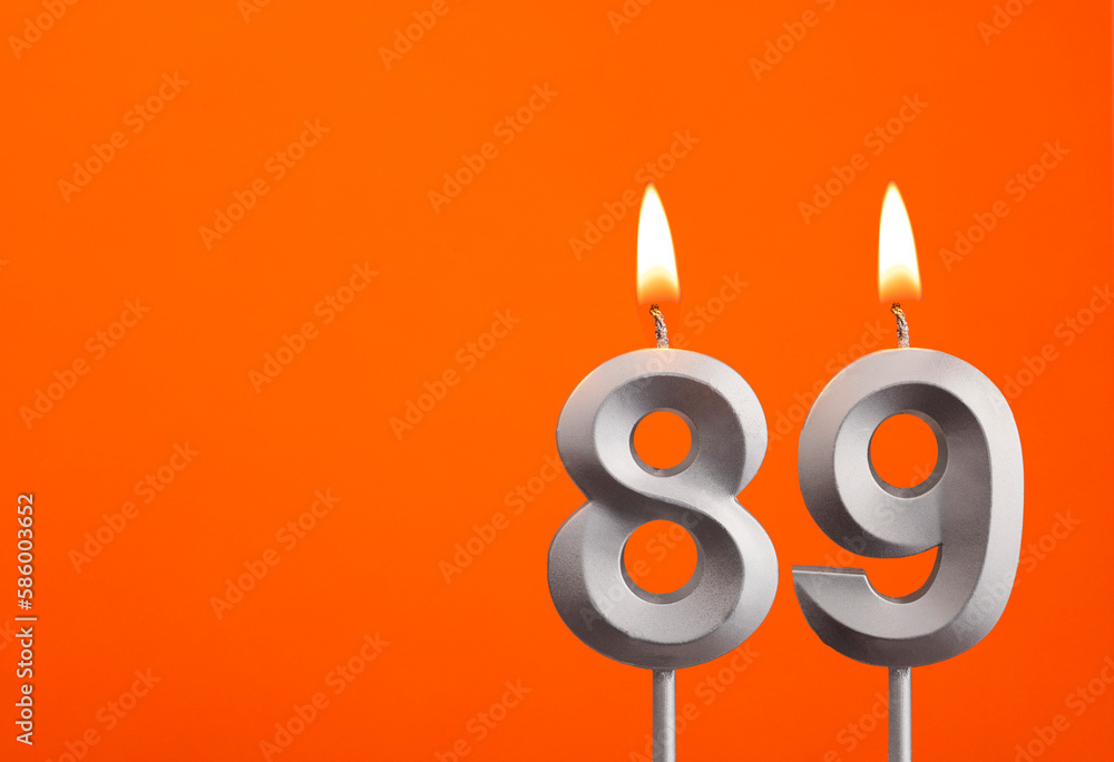 Candle number 89 - Birthday in orange background Candle number 89 - Birthday in orange background