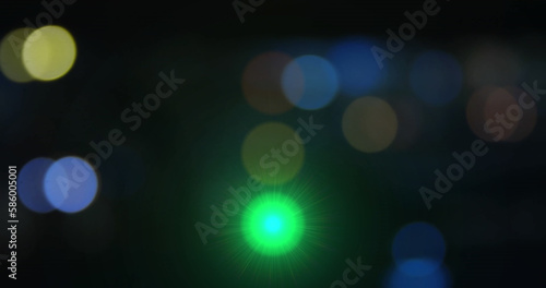 Comosition of traffic lights over light spots on black background photo