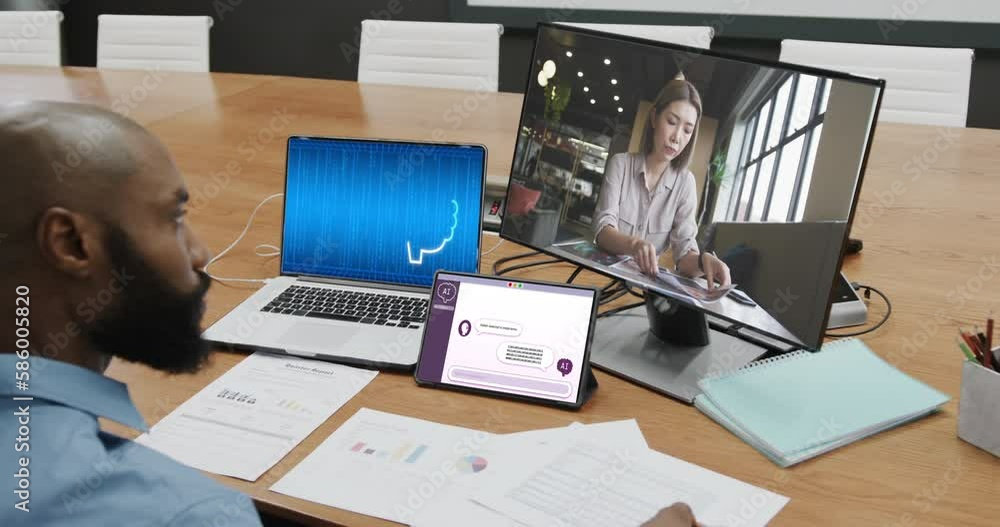 Diverse business people on computer video call with data processing on laptop in office Diverse business people on computer video call with data processing on laptop in office