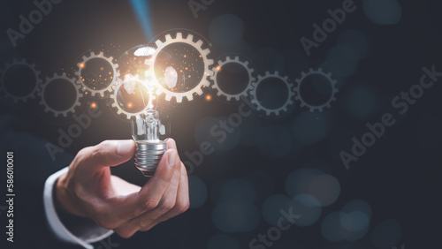 businessman holding a light bulb ,team business success concept , cooperation and support colleagues ,brainstorming ,corporate teamwork ,Successful business team ,Building a team to work together