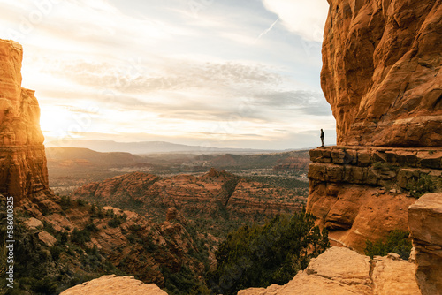 Woman looking out at dramatic sunset from Cathedral Rock.