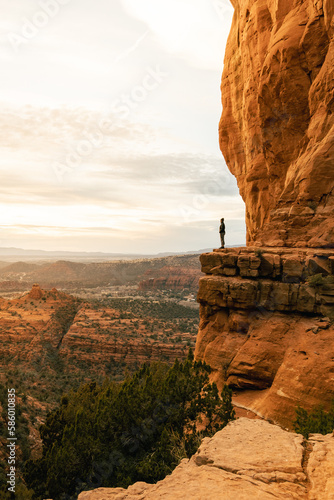 Woman looking out at dramatic sunset from Cathedral Rock.