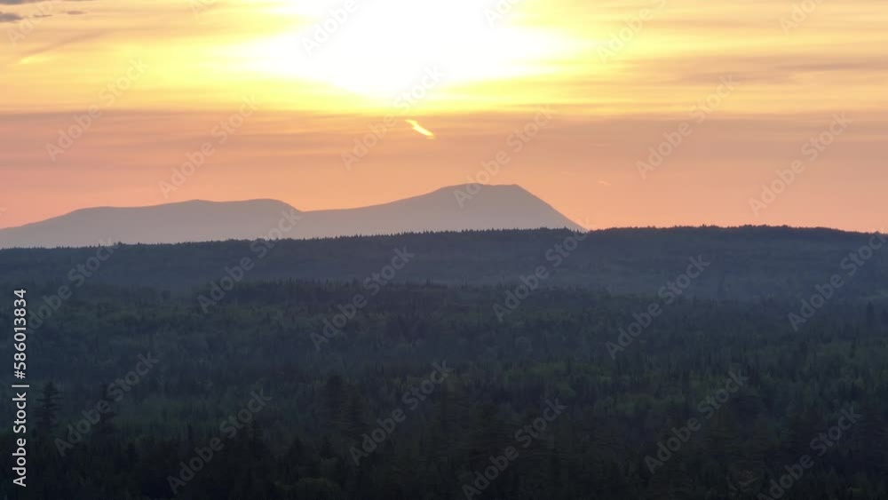 The setting sun beyond the mountains of Maine The setting sun beyond the mountains of Maine