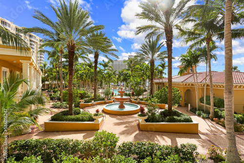 Naples, Florida Luxury Living Community with Large Palm Trees on a Courtyard and a Fountain in the Middle photo