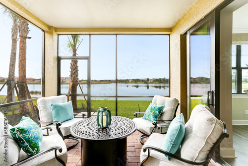 Tableau sur toile Patio with Luxury Furniture on a Clear Day and Clear Lake in the Background with