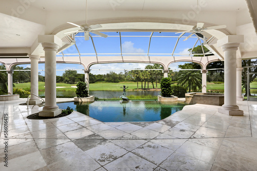 Luxury Lanai Pool with View of Golf Course in Gated Community in Naples, Florida Featuring Beautiful Landscaping