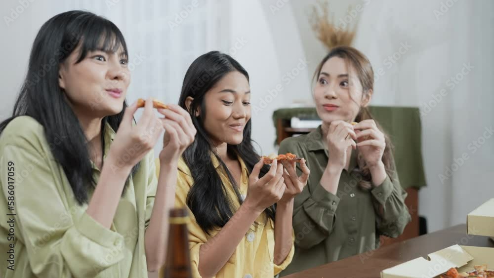 Holiday concept of 4k Resolution. Group of Asian female friends eating pizza together at home. Fun and exciting leisure activities. Holiday concept of 4k Resolution. Group of Asian female friends eating pizza together at home. Fun and exciting leisure activities.