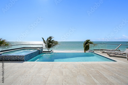 Beach View with Pool and Hot Tub Jacuzzi in the Foreground and Clear Skies with the Gulf of Mexico in the Background