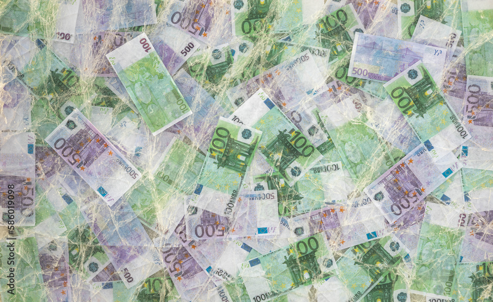 Blurred photo of one hundred and five hundred euros are defrosted in ice. The European cash currency is frozen.