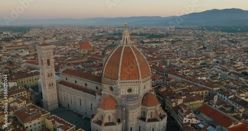 Aerial Shot Of Cupola Del Brunelleschi At Sunset, Drone Panning Over City Against Sky - Florence, Italy photo
