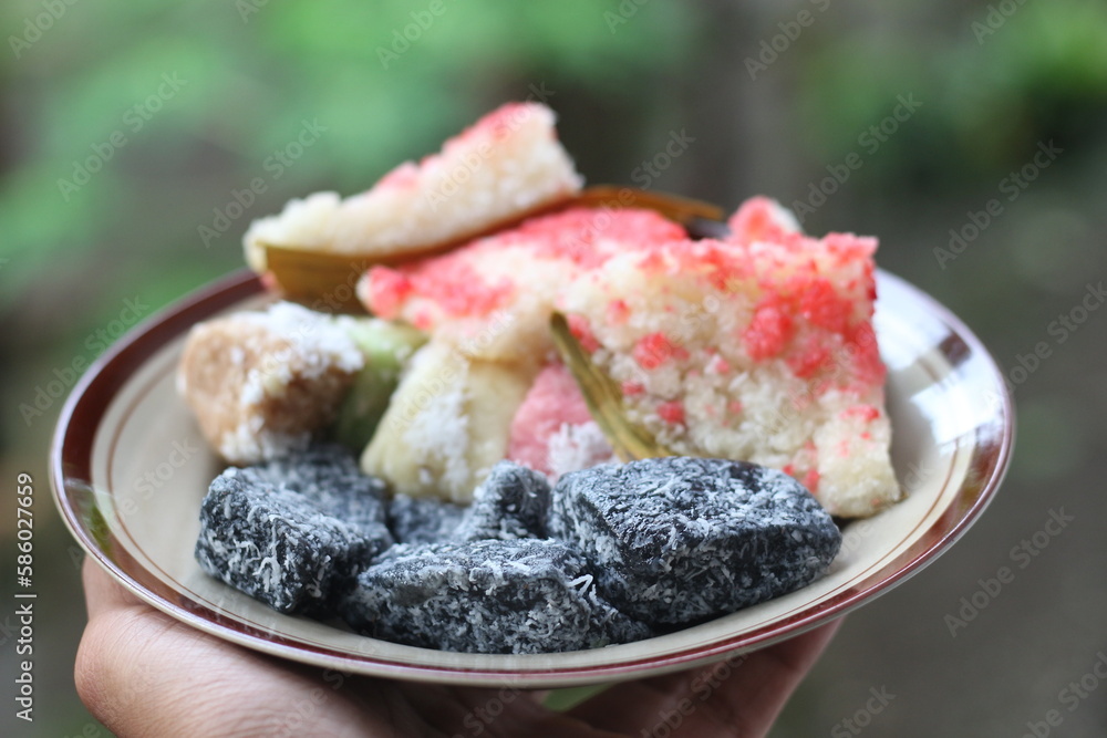 sengkulun, cenil, and getuk served on a plate and ready to eat. sengkulun, cenil, and getuk served on a plate and ready to eat.