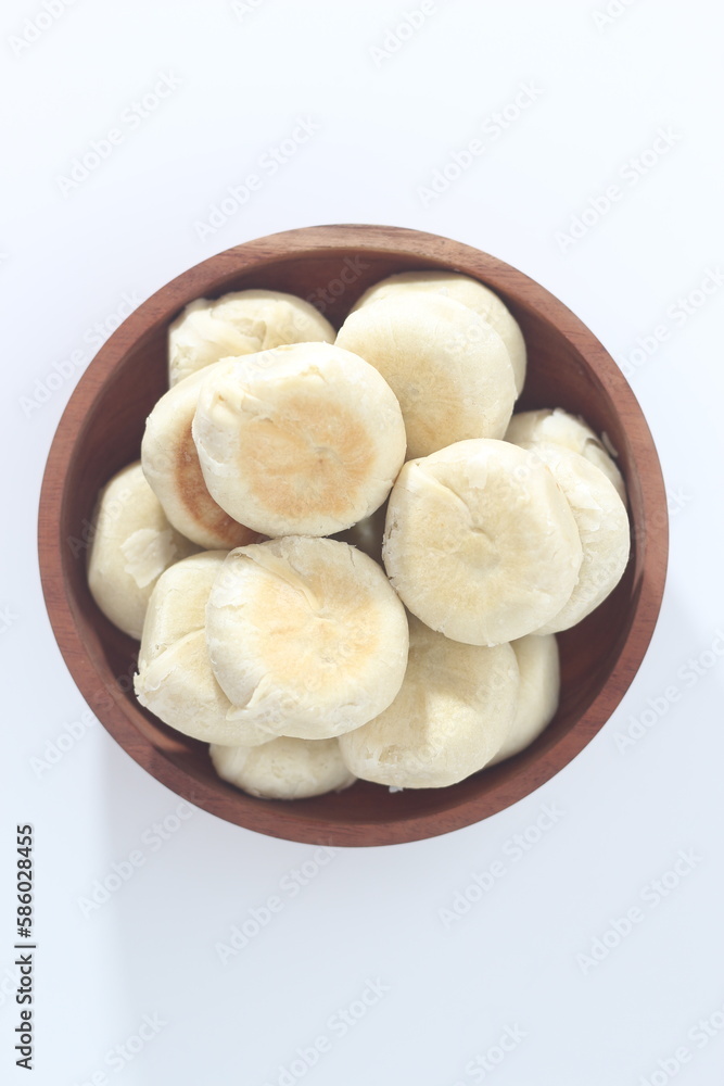a close up of Bakpia served in a wooden bowl a close up of Bakpia served in a wooden bowl