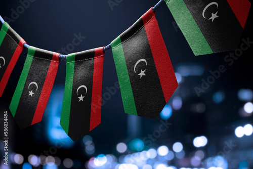 A garland of Libya national flags on an abstract blurred background photo