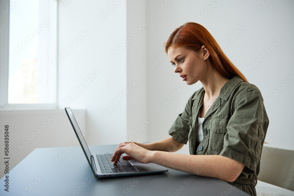 portrait of a cute woman sitting at work at a laptop and thinking things over portrait of a cute woman sitting at work at a laptop and thinking things over