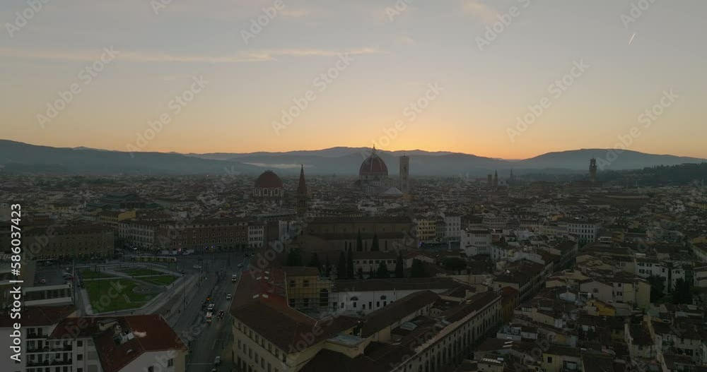 Aerial Forward Shot Of Vehicles Moving Road In City With Historical Landmark At Sunset - Florence, Italy Aerial Forward Shot Of Vehicles Moving Road In City With Historical Landmark At Sunset - Florence, Italy
