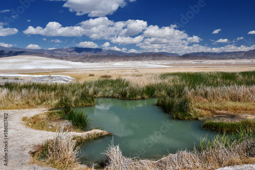 Tecopa Hot Springs in southern California on a sunny day, near the Mojave desert south of Death Valley. Cloudy blue sky