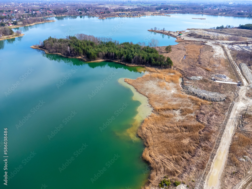 Aerial view landscape. Green water, sand, empty space, abandoned factory.