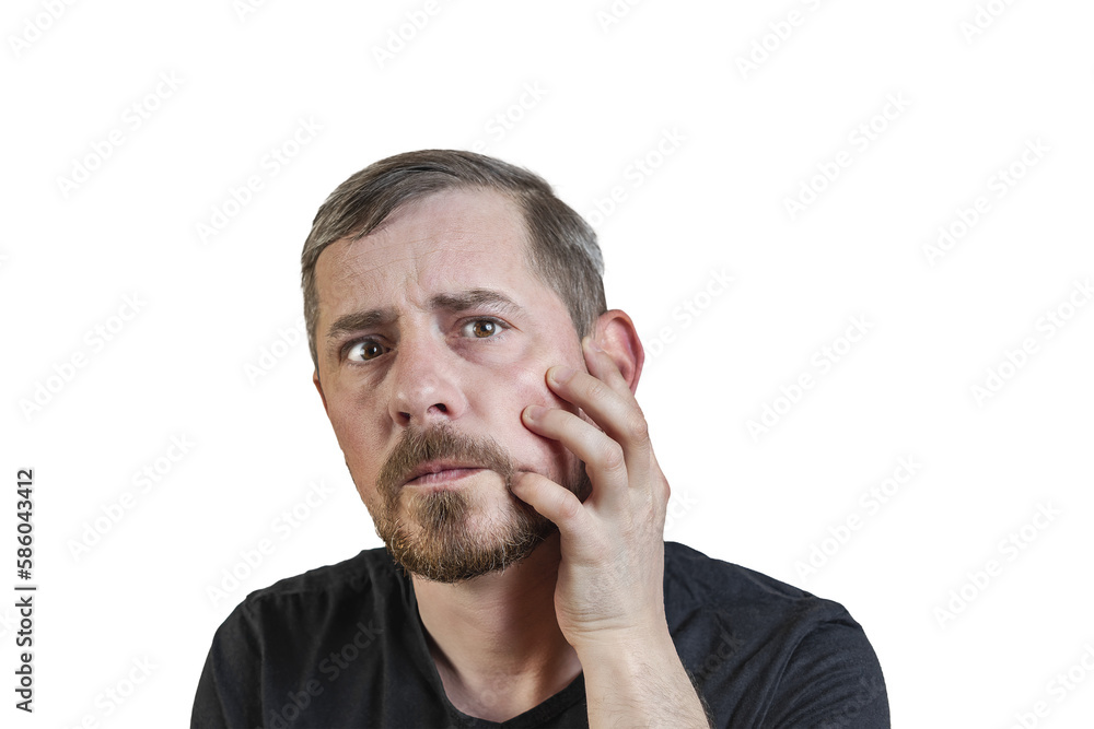 Portrait of an attractive bearded man of European appearance, with a slight gray hair, on an isolated white background. Holds a hand on the cheek. Expression of emotions of a man. Portrait of an attractive bearded man of European appearance, with a slight gray hair, on an isolated white background. Holds a hand on the cheek. Expression of emotions of a man.