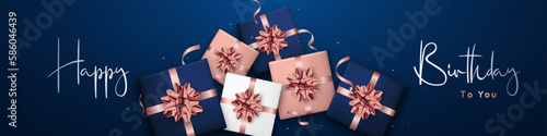 Happy Birthday long horizontal banner. Background Birthday design of rose gold, blue and white gift boxes. Flat lay top view. Design template for web sites, social media.