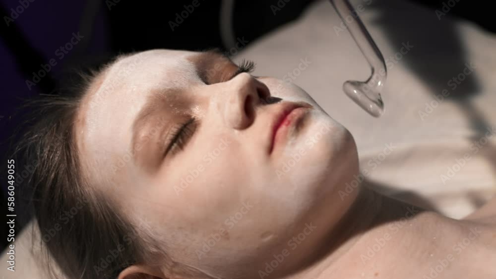 Massage of the patient's face in the spa using Darsonval Massage of the patient's face in the spa using Darsonval